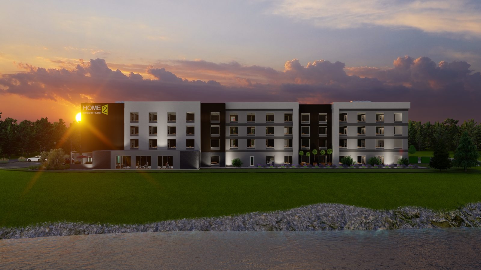 Sunset rendering of the long elevation beside water, with the illuminated Home2 sign.