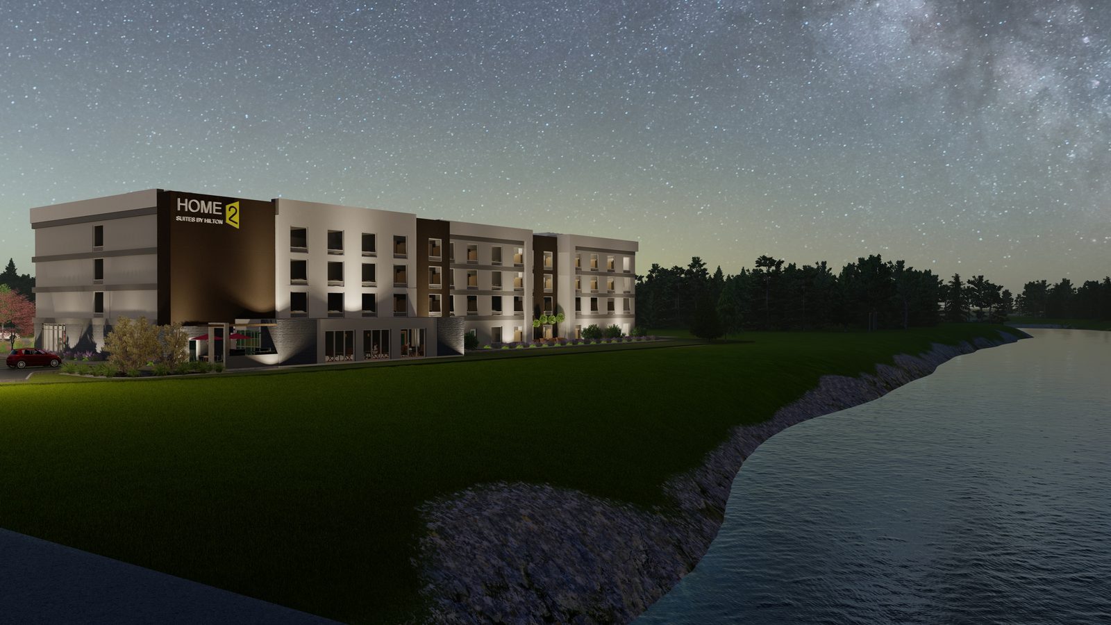 Night rendering of the Home2 Suites by Hilton beside water under a starry sky, with the guest-room wing illuminated.