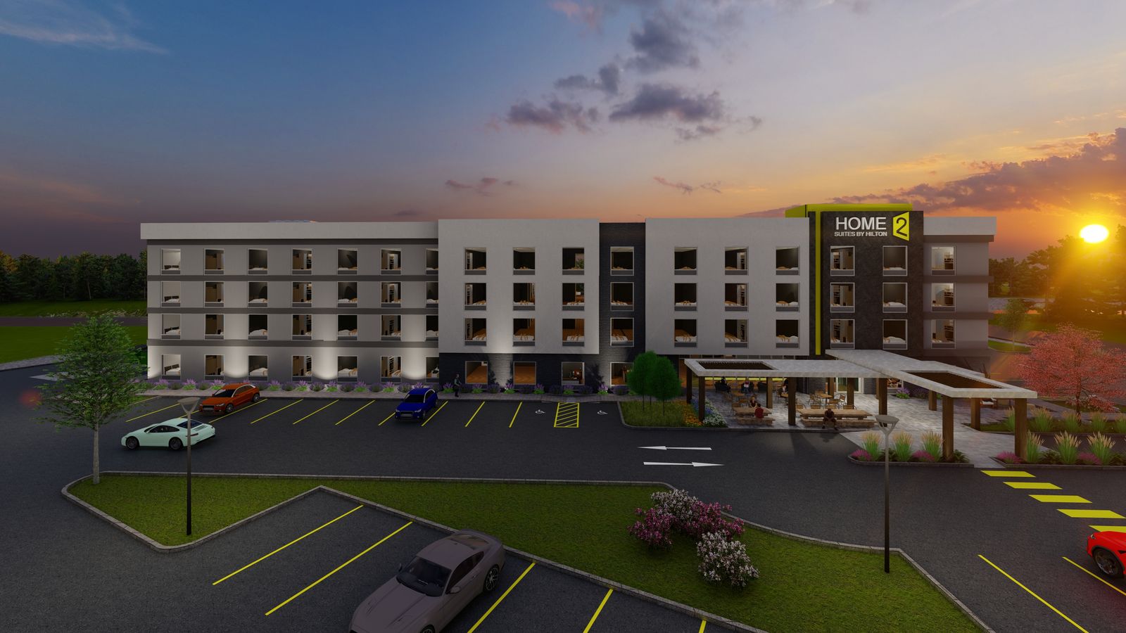 Dusk rendering of the hotel from the parking lot, entry canopy and brand tower at right.