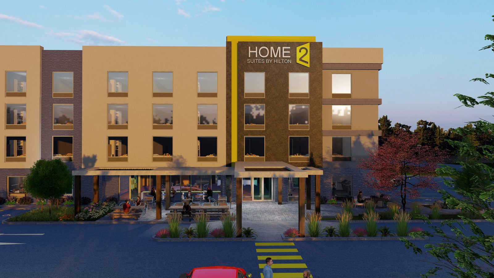 Daytime rendering of the Home2 Suites entry elevation with porte-cochere, outdoor patio dining and brand signage.