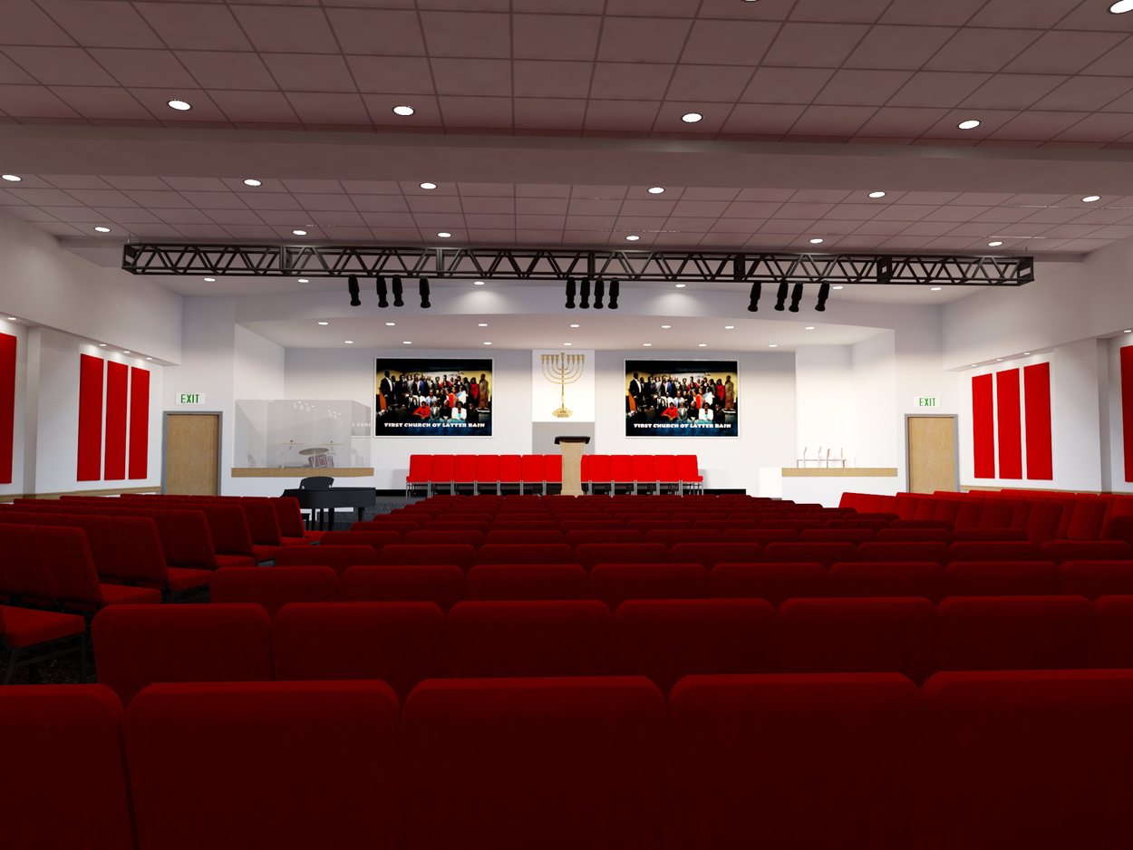 Sanctuary interior with red seating, raised stage and church signage