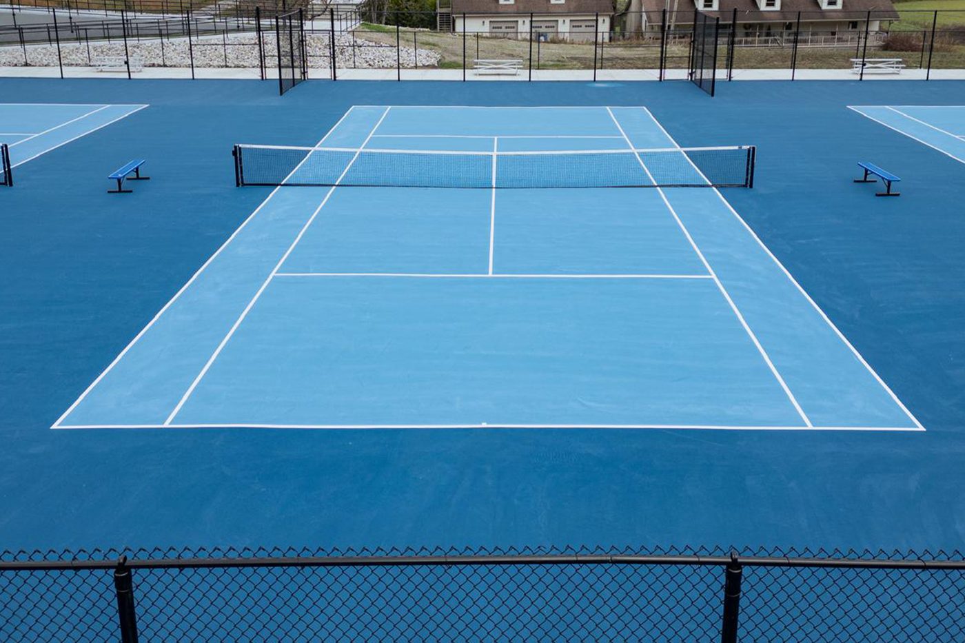 Ground-level view down a championship court with net