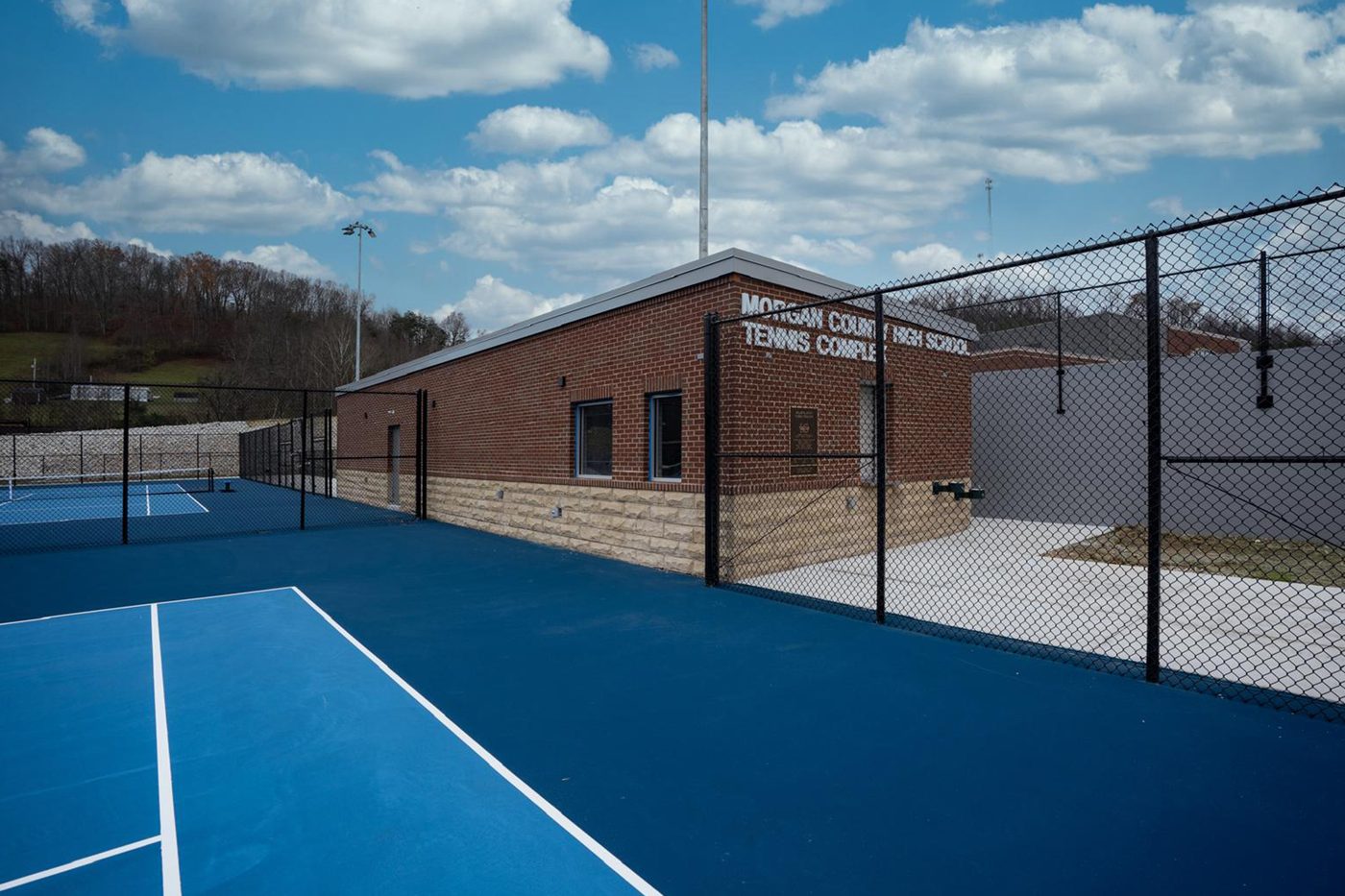 Close view of the support building and adjacent courts